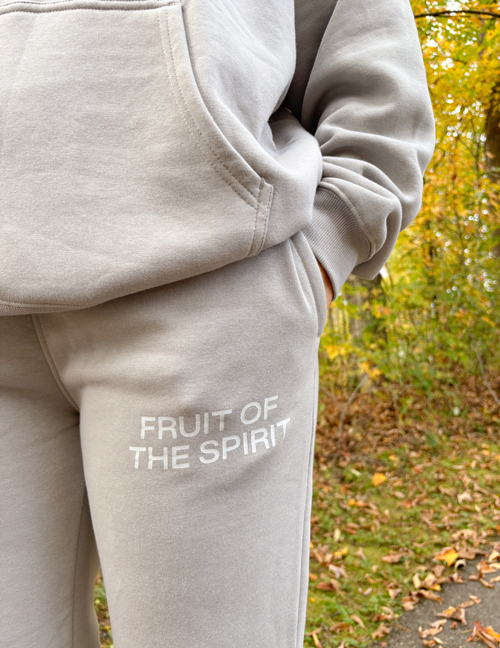 Grey sweatpants close-up showing large thigh logo on left leg