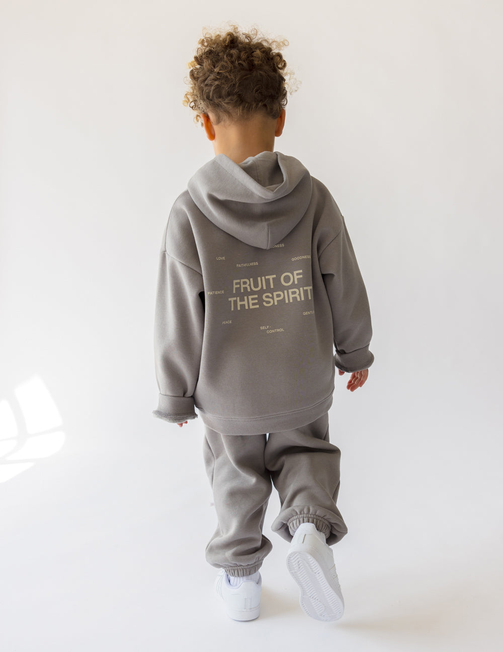 Kids gray pullover hoodie, back graphic text visible, hood and front pocket