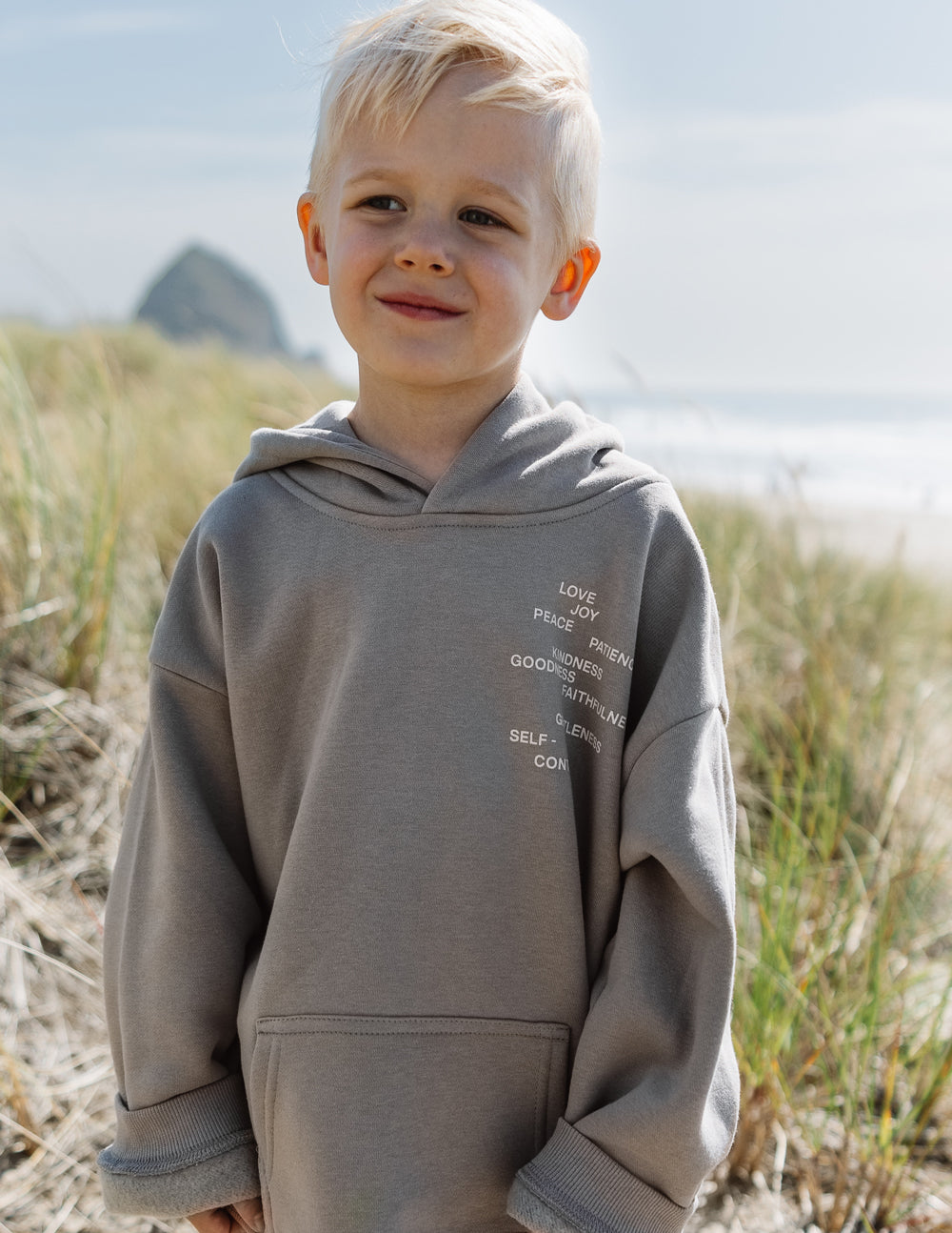 Kids gray hoodie with hood and front pocket, printed word list on chest