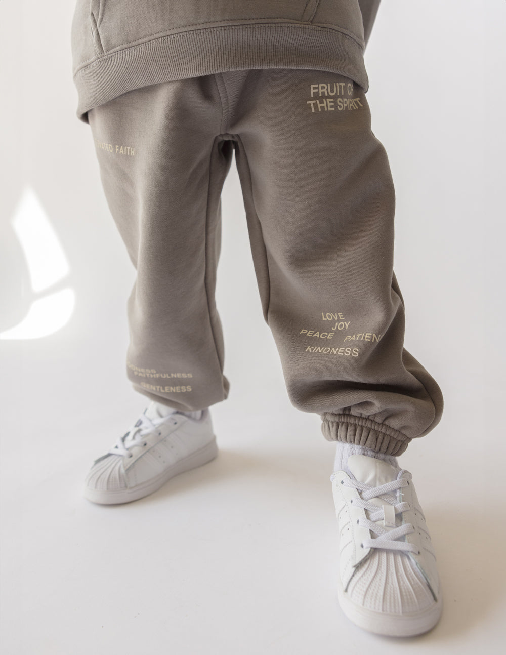 Kids sweatpants in heather gray with printed virtue words on the legs