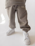 Kids sweatpants in heather gray with printed virtue words on the legs