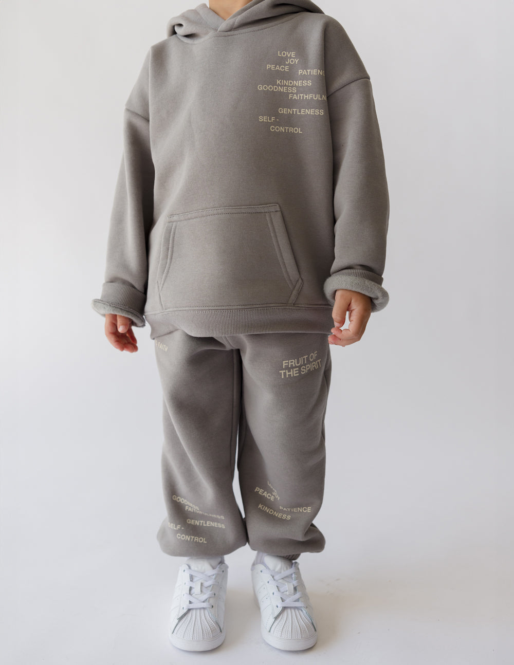 Kids sweatpants in heather gray with printed text on the thighs and hem