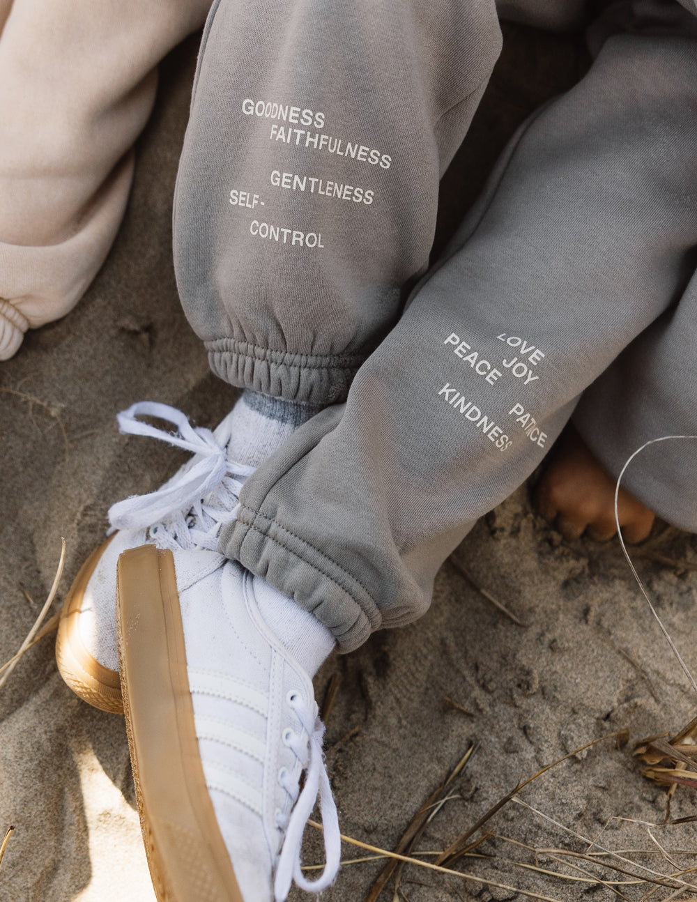 Kids sweatpants with printed virtue words near the ankle cuff and elastic hem