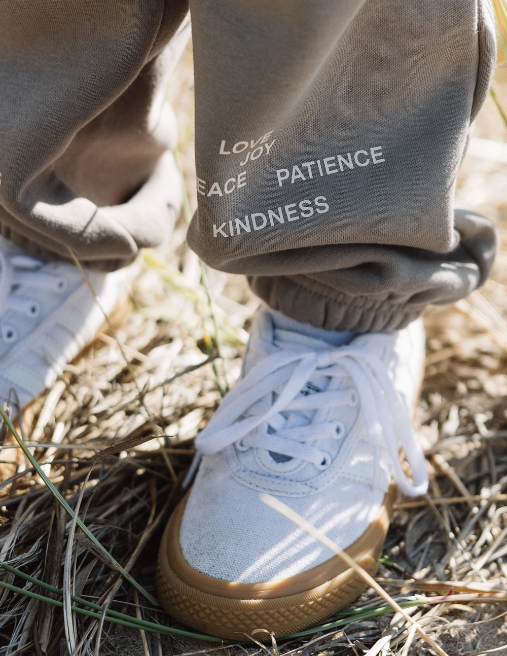 Kids sweatpants close-up with printed words on the leg and elastic cuff