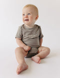 Taupe short-sleeve baby onesie with 'Fruit of the Spirit' chest graphic