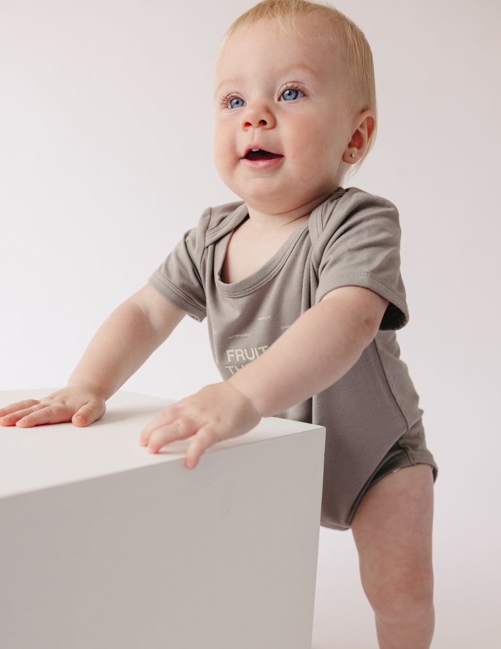 Taupe baby onesie with 'Fruit of the Spirit' front print