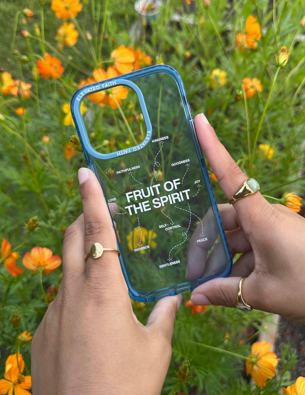 Blue Fruit of the Spirit phone case held in two hands; clear back with spiritual text