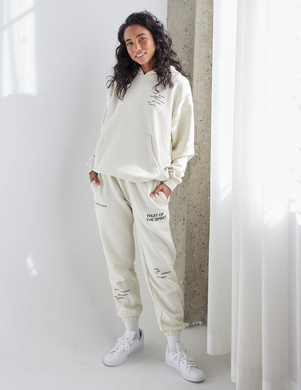 Unisex off-white hoodie with front logo and relaxed fit, shown from front and side