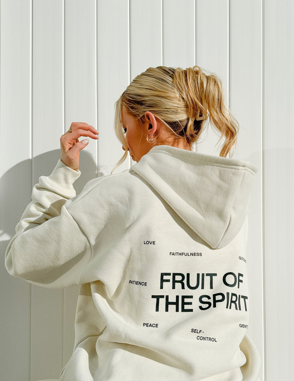Off-white unisex hoodie with large back text design and smaller word list near shoulders