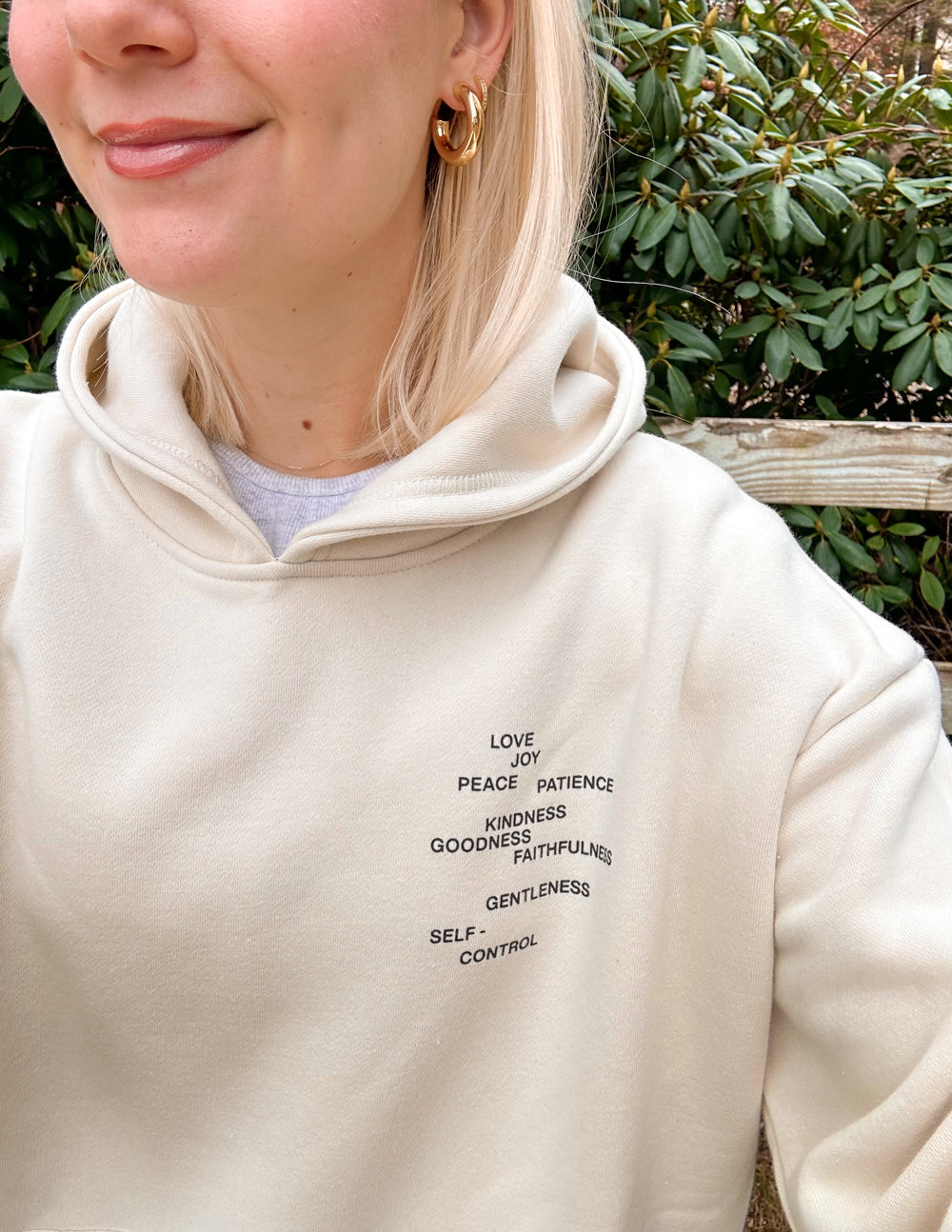 Cream unisex hoodie with small front word graphic
