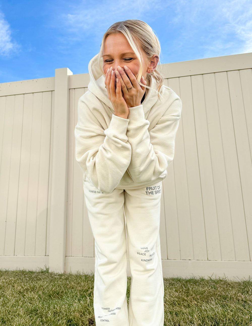 Cream unisex sweatpants with small printed marks and cuffed ankle hems