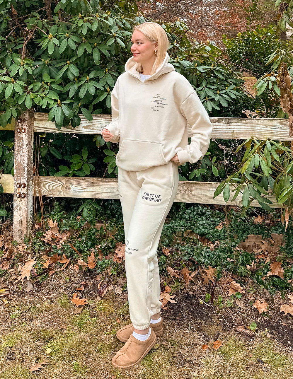 Cream unisex sweatpants with printed thigh text and cuffed ankle cuffs