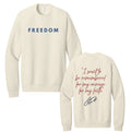 Cream crewneck sweatshirt with long sleeves and front text "FREEDOM"