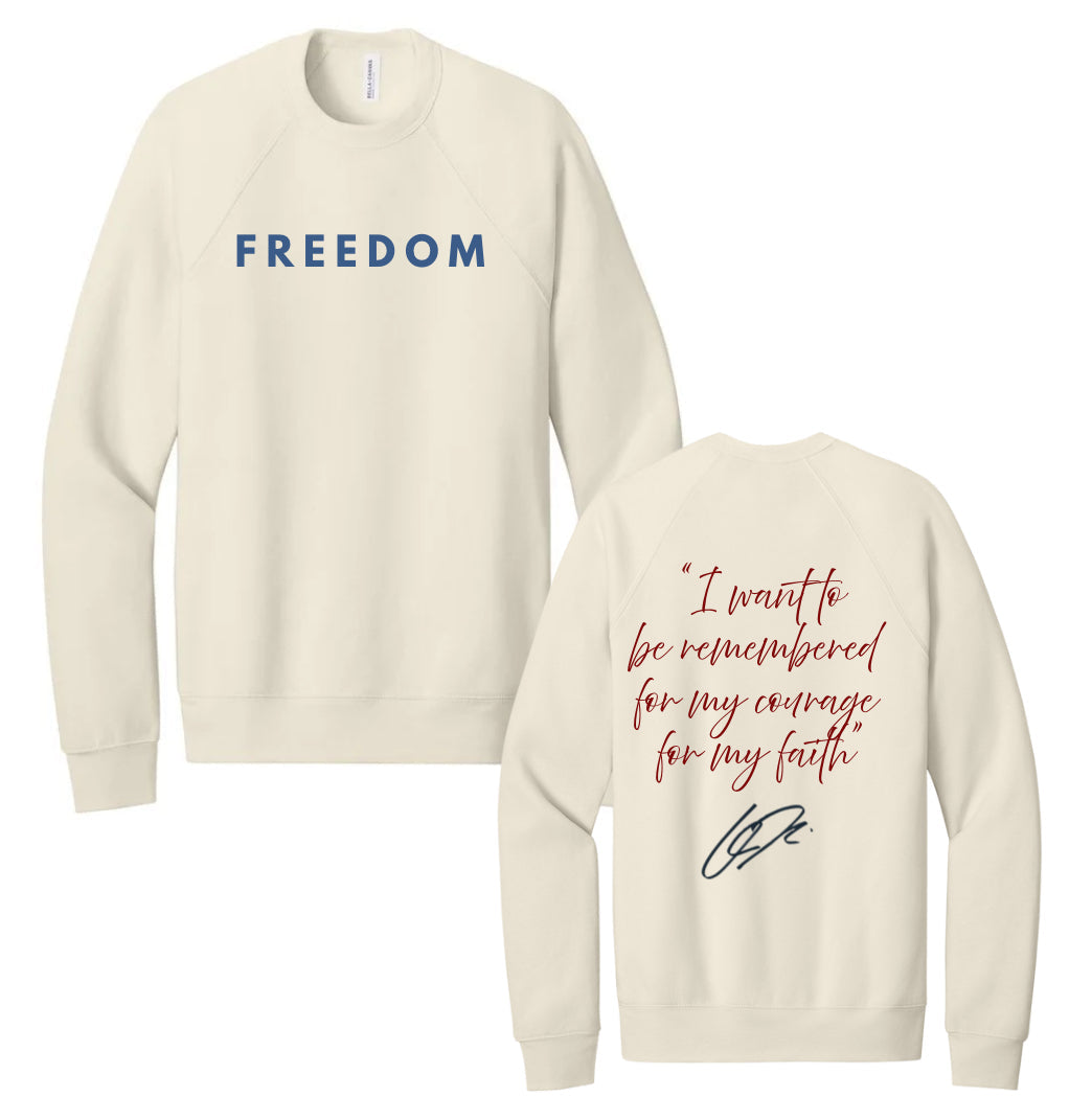 Cream crewneck sweatshirt with long sleeves and front text "FREEDOM"