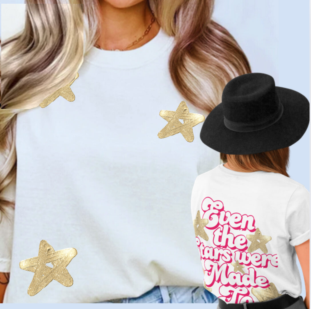 White faith t-shirt with gold star graphics and colorful "Made" text