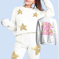 Cream sweatsuit set with sweatshirt and pants, gold stars and “Even the stars…” graphic