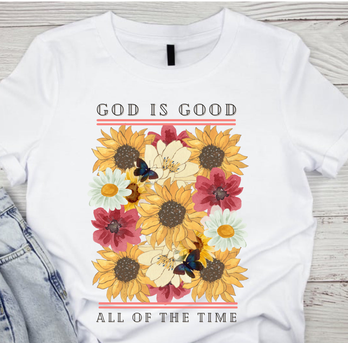 White graphic T-shirt with 'God is Good' text and colorful sunflower floral design