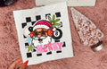 White tee with colorful Santa hat graphic and 'MERRY' lettering