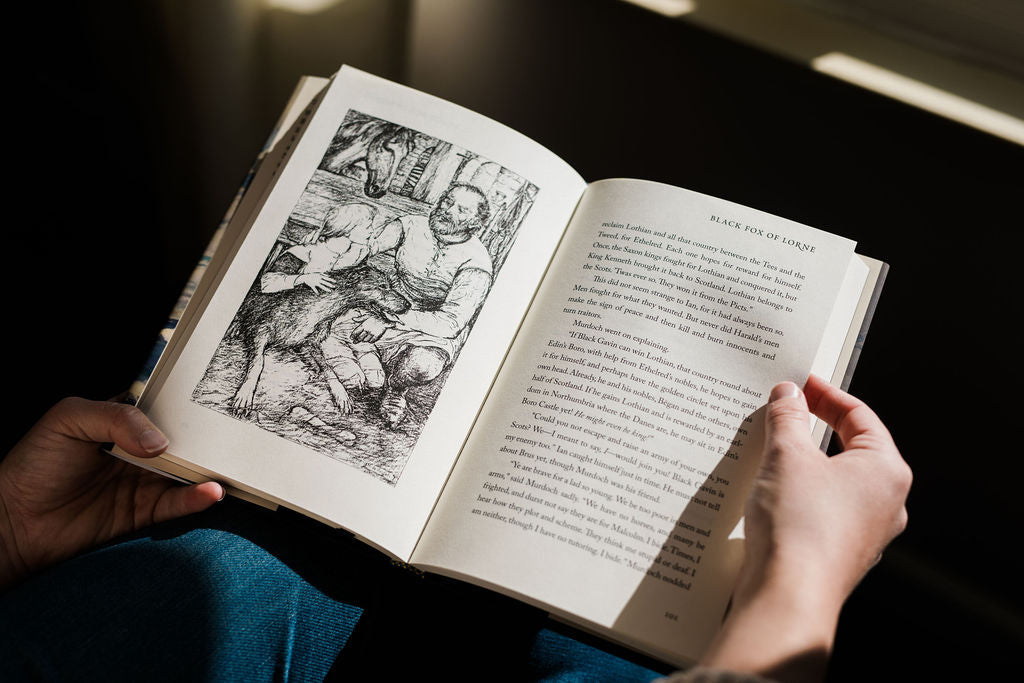 Open book spread with black-and-white engraving and printed text pages