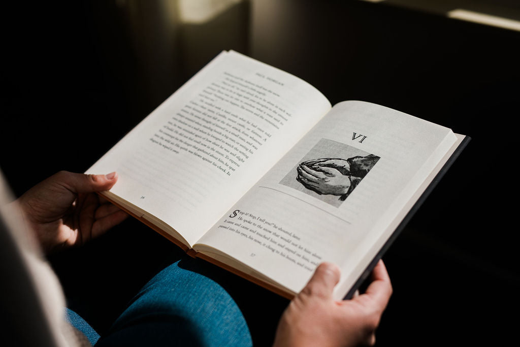 Open book with printed text and small grayscale illustration on page VII