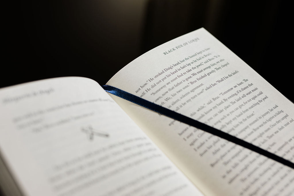 Close-up of open book pages with dense printed paragraphs