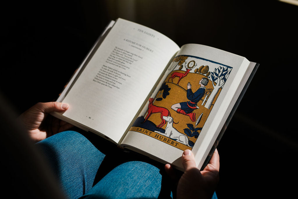Open Saints book with printed text and an illustrated scene on the right page