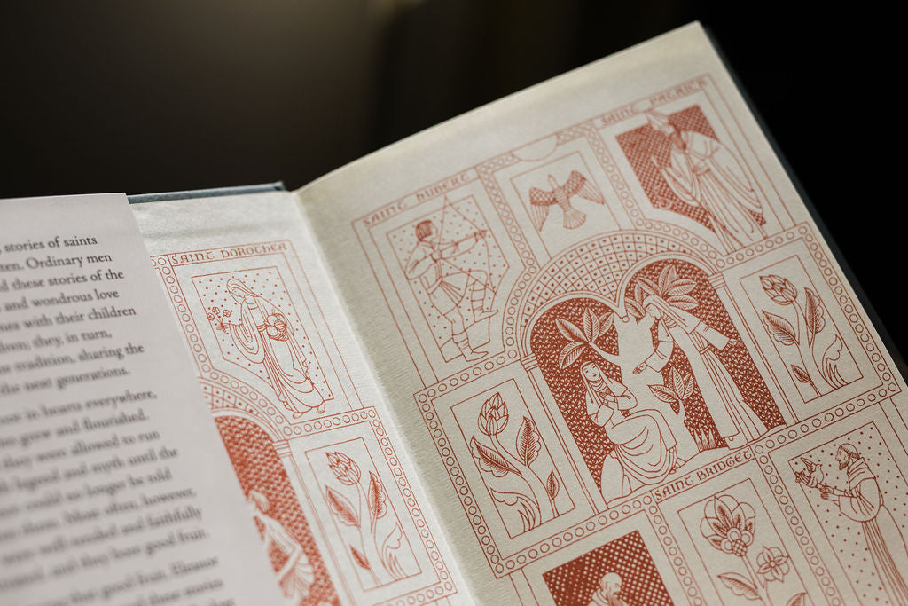 Open Saints book with decorative illustrated panels and ornate border artwork