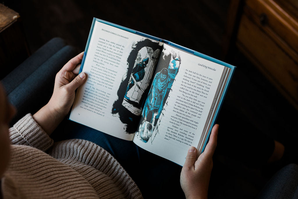 Hardcover book open with left-page character illustration and printed text on right