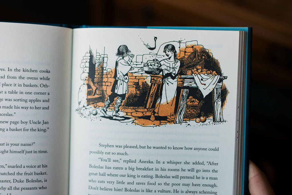 Hardcover book open to illustrated dining scene with surrounding paragraph text