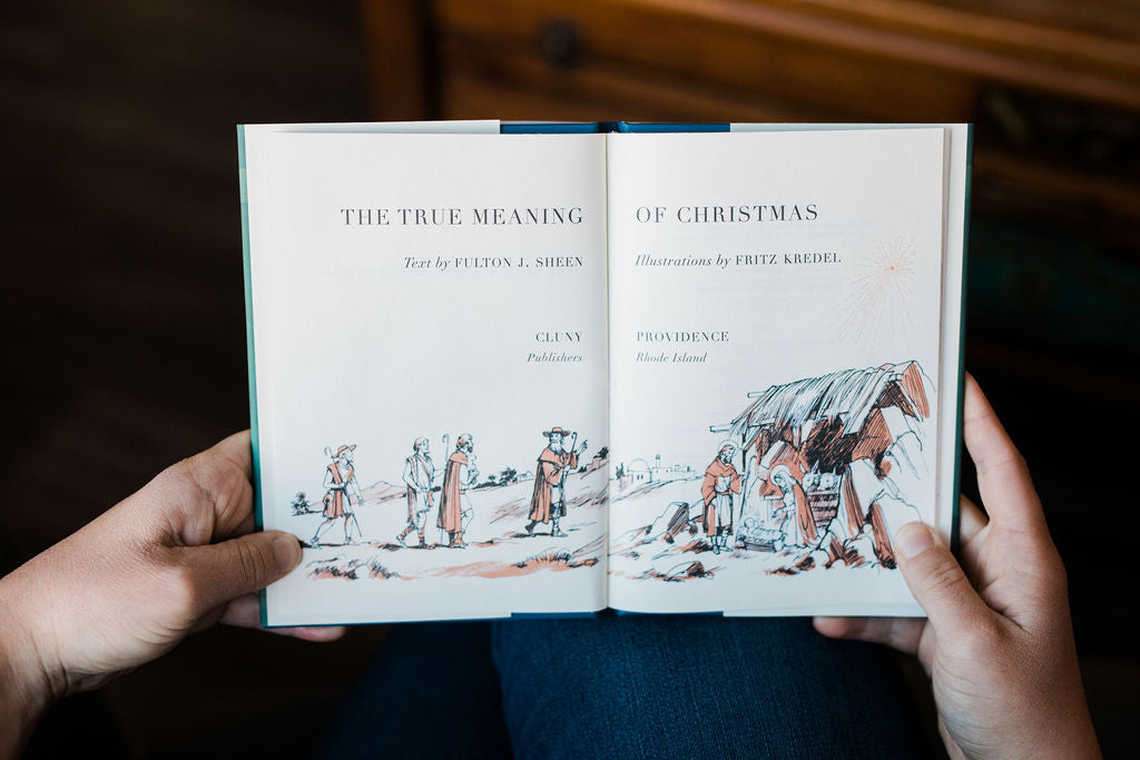 Open Christmas book showing illustration and chapter title pages