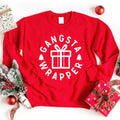 Red crewneck sweatshirt with circular “Gangsta Wrapper” gift graphic and long sleeves