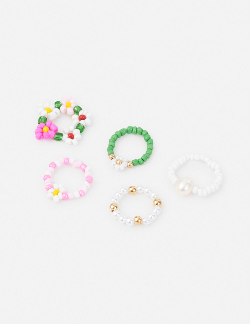 Beaded ring set with flower and pearl accents, colorful and green bands, gold-tone details