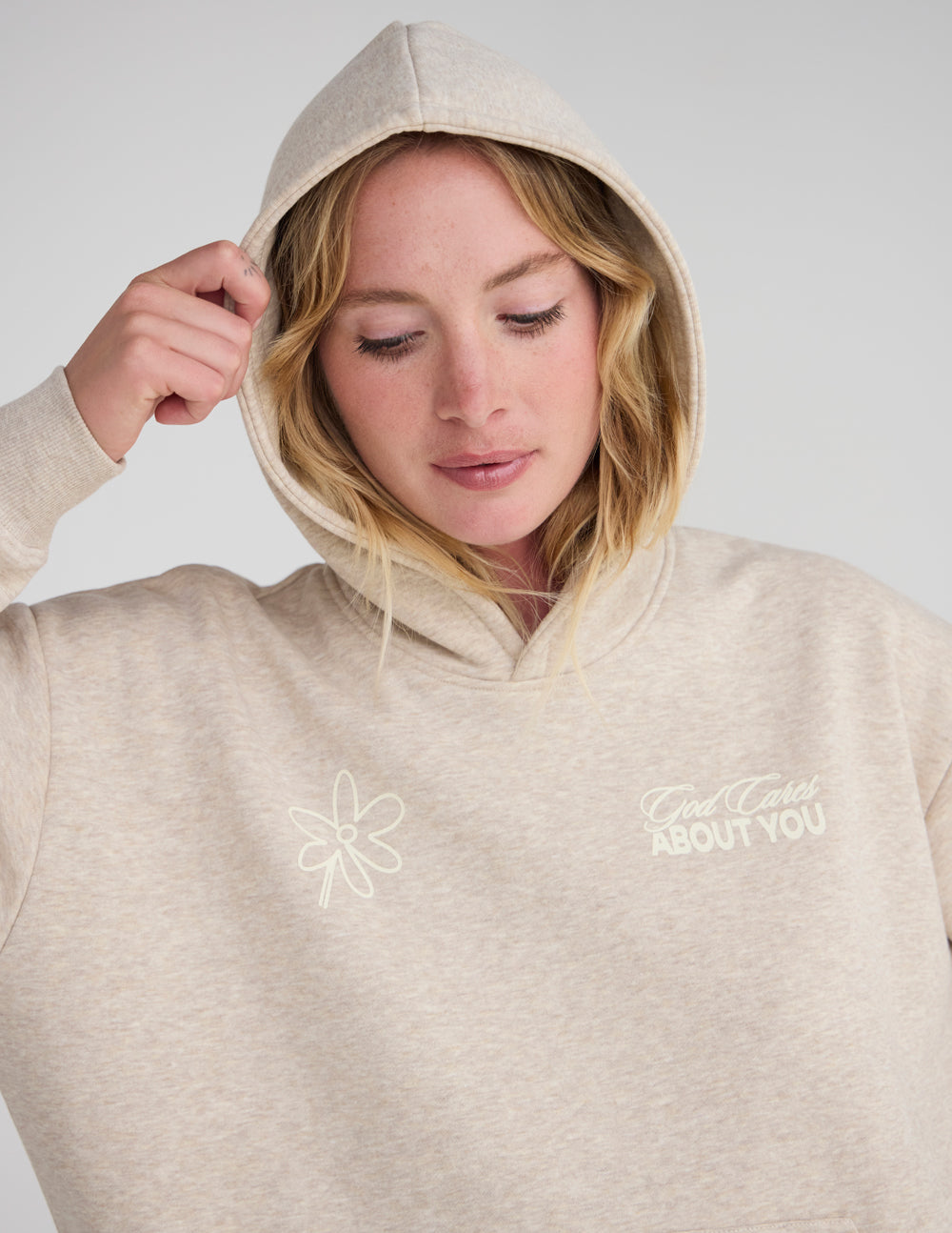 Unisex hoodie in light beige with front logo and flower graphic