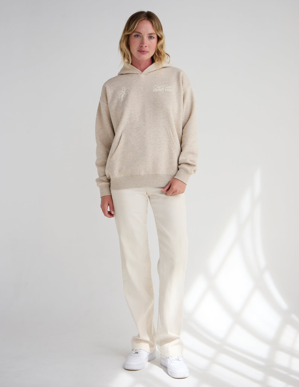 Unisex light beige hoodie with kangaroo pocket and subtle chest logo