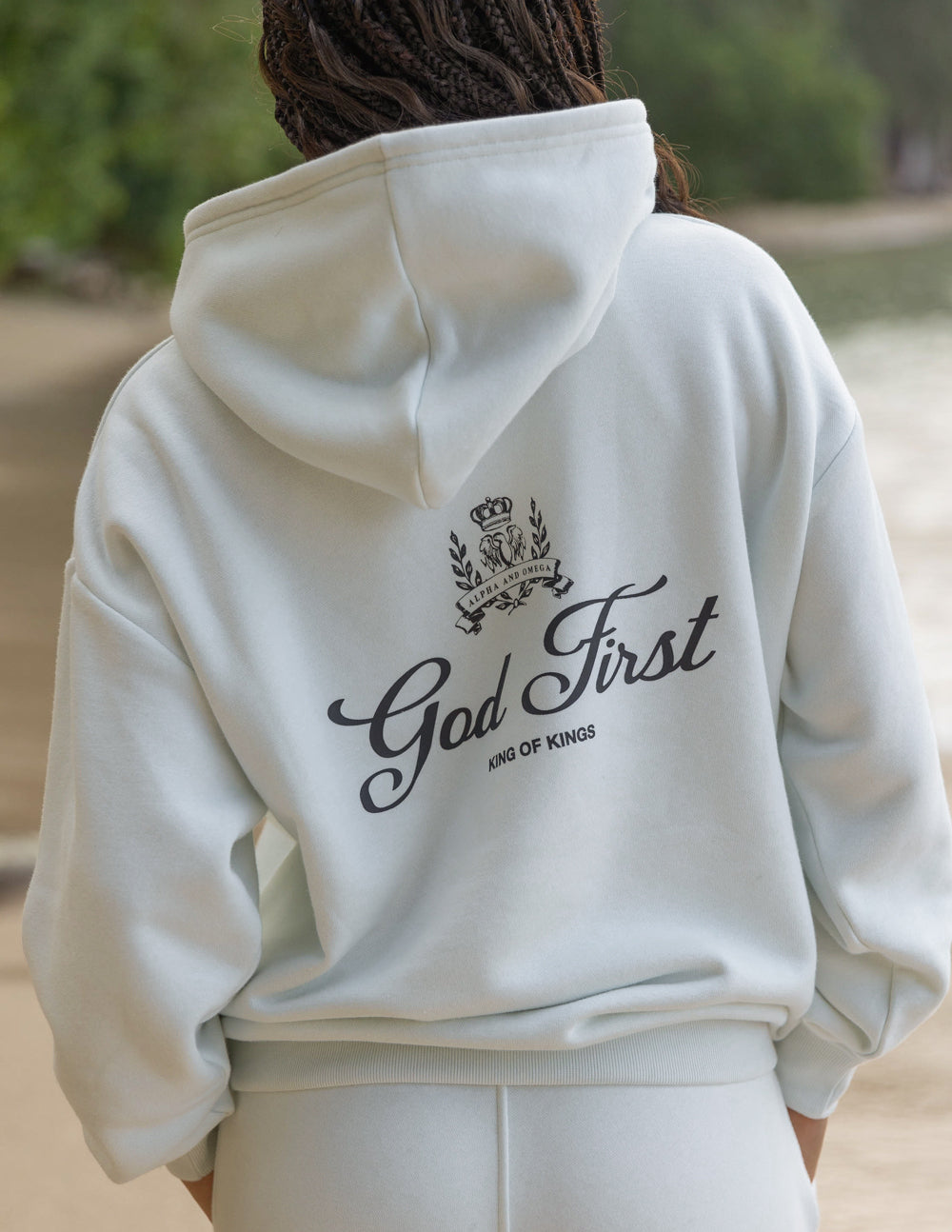 Unisex light cream hoodie with back God First crown graphic and drawstring hood