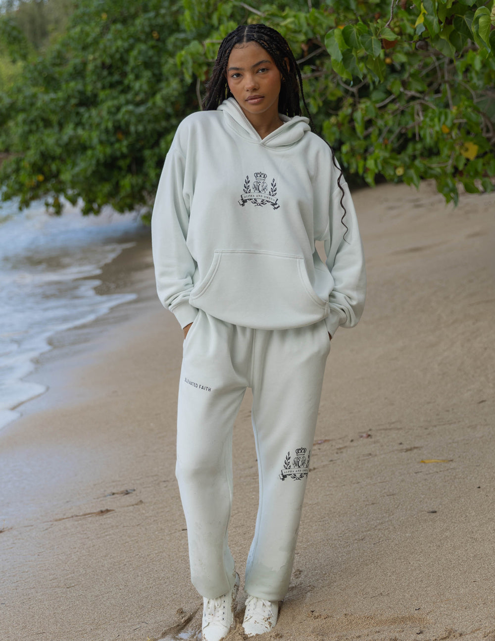 Unisex light cream hoodie with embroidered chest crest and front pouch pocket