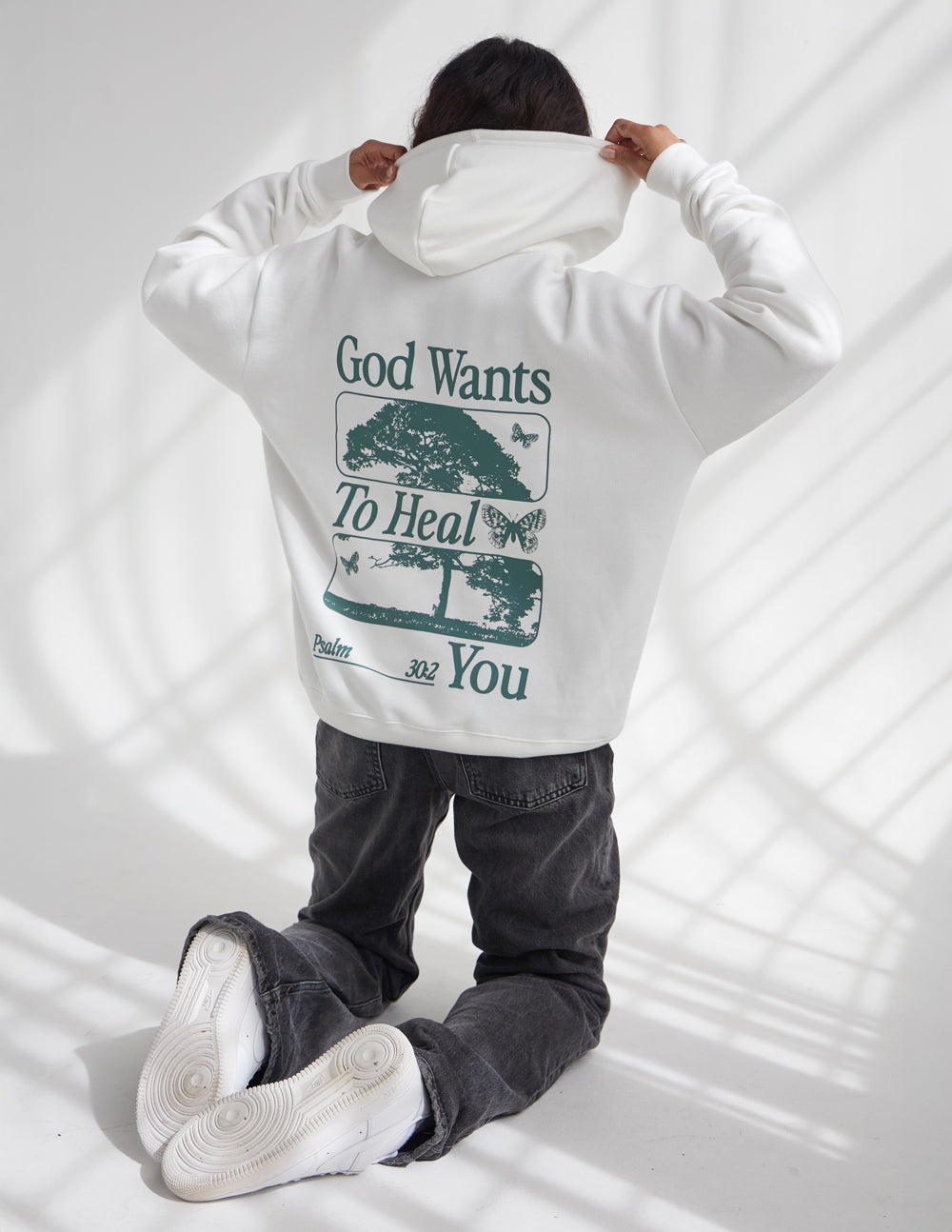 White unisex hoodie with large green back graphic and hood