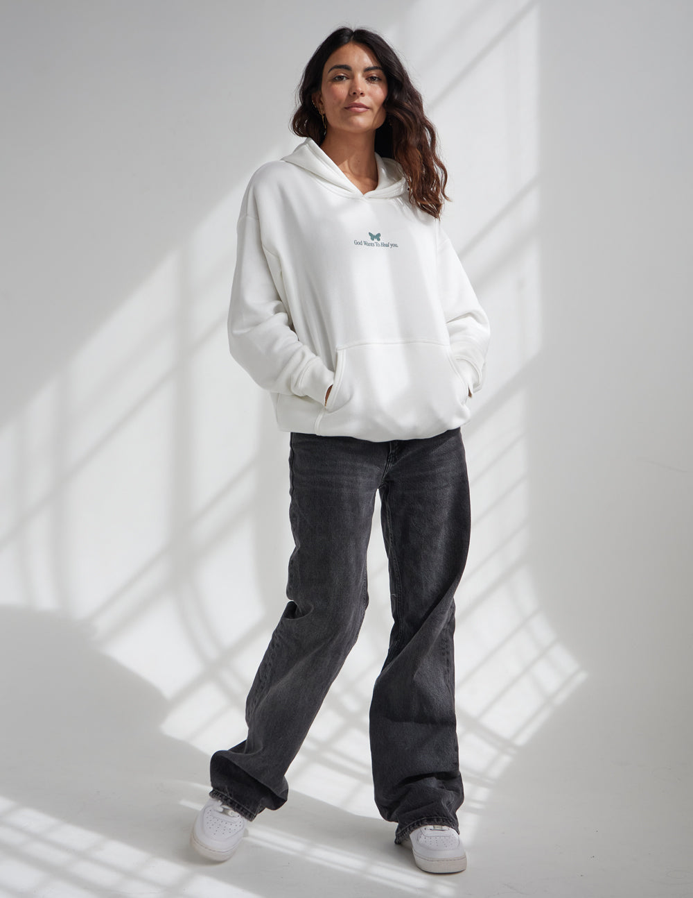 White unisex pullover hoodie with small chest logo and front pouch pocket
