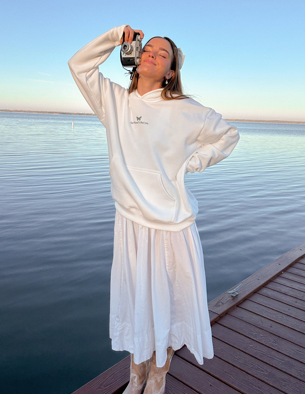 White unisex hoodie with green chest logo and front kangaroo pocket