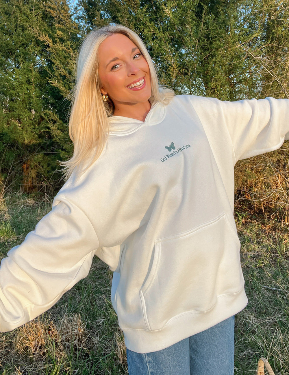 White unisex hoodie with green chest logo and relaxed hooded neckline