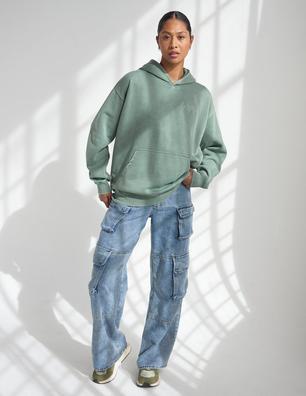 Sage green unisex hoodie with front pocket, pullover hood, and relaxed fit