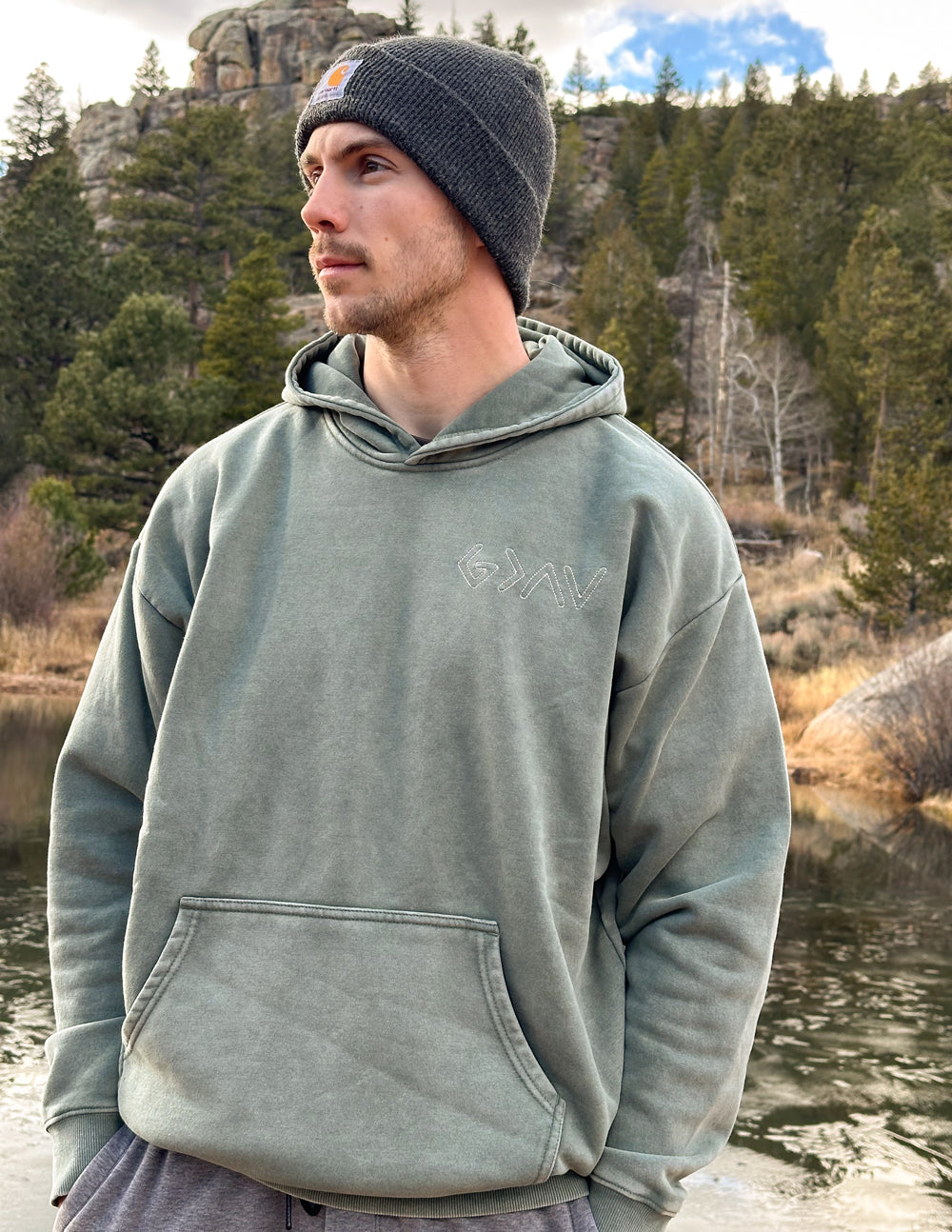 Sage green unisex hoodie with pullover hood and front pocket on a beanie