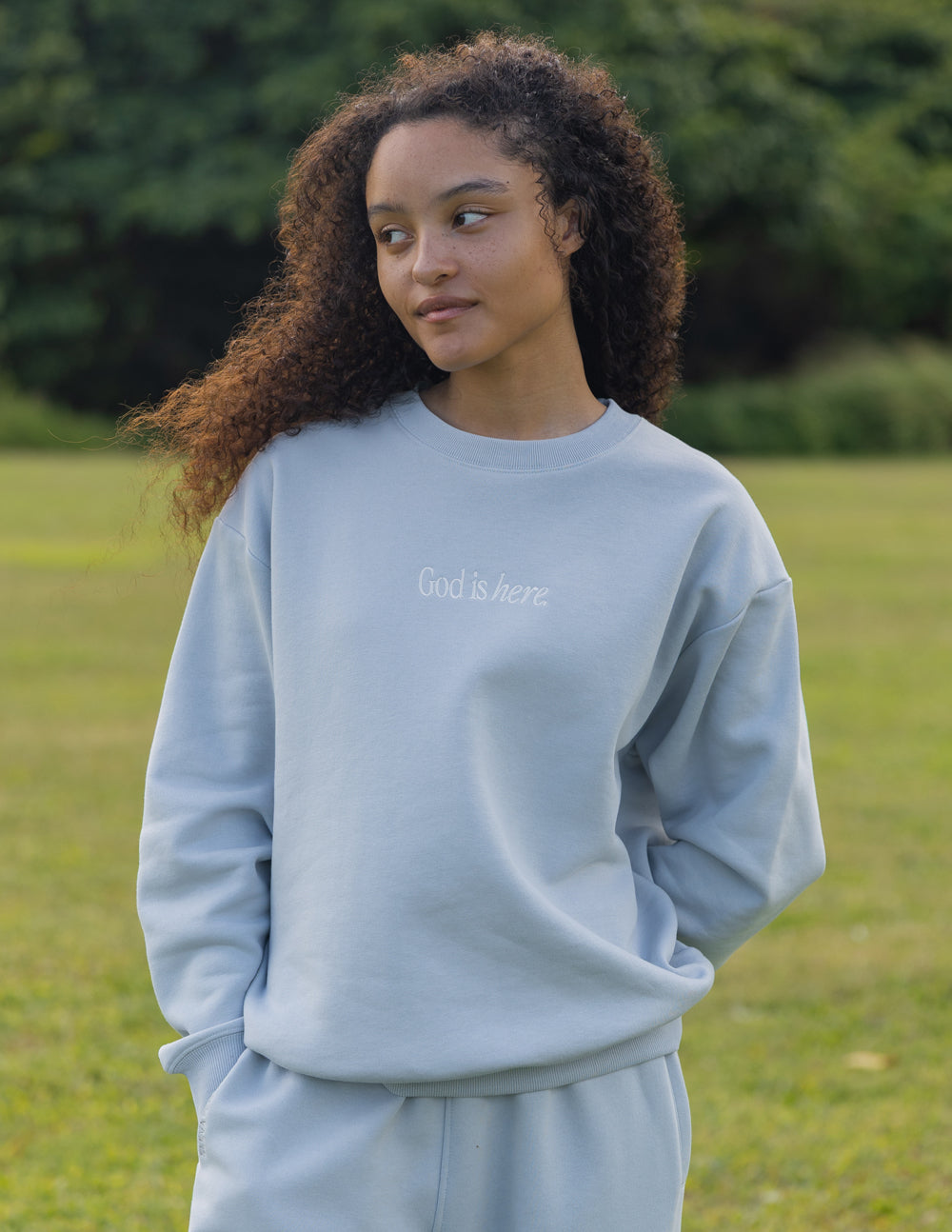 Light blue unisex crewneck sweatshirt with small chest text and crew neckline