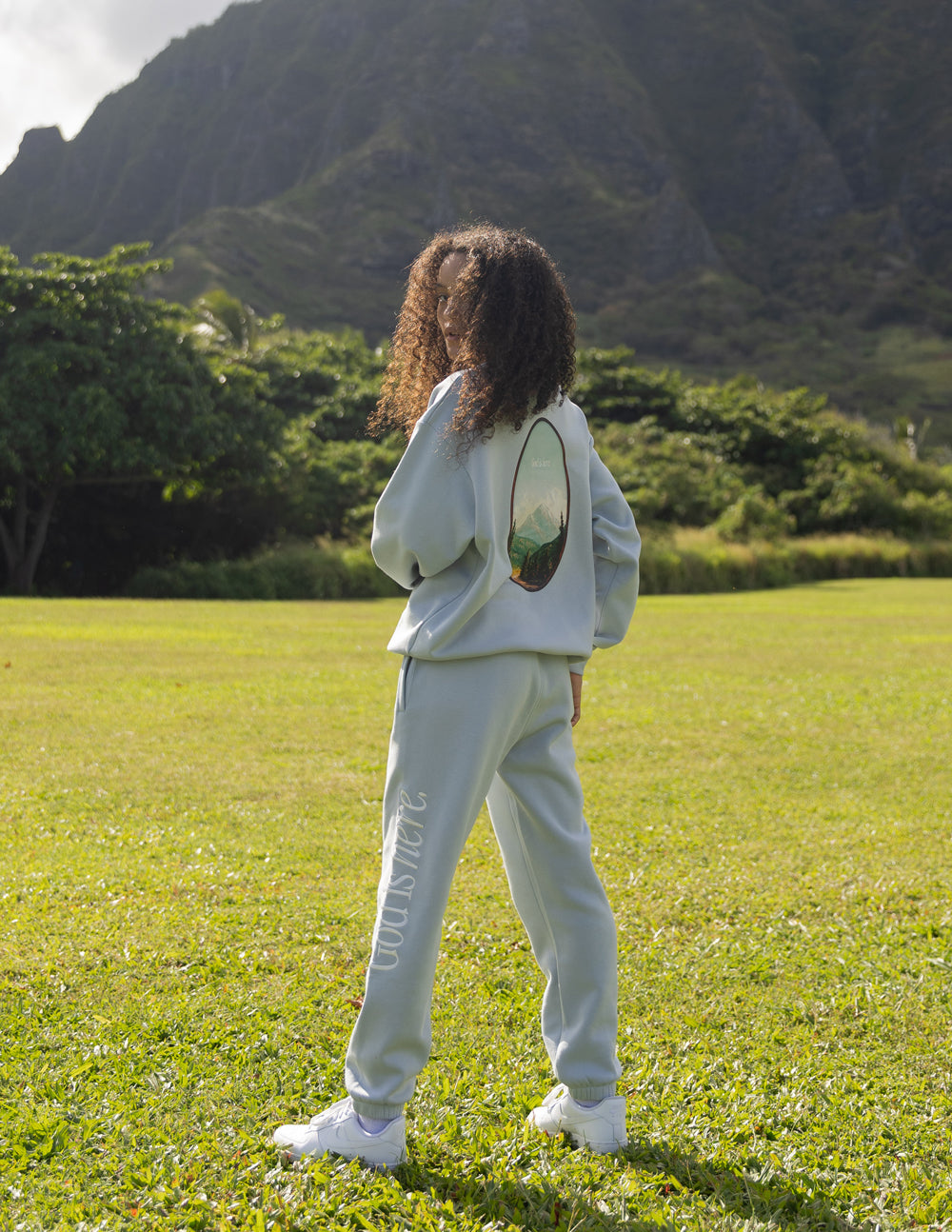 Light blue unisex crewneck sweatshirt with oval back graphic and dropped shoulders