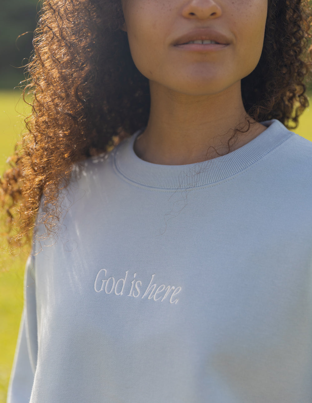Light blue unisex crewneck sweatshirt with small white chest text