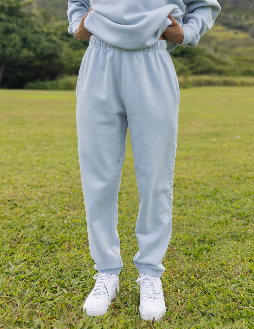 Light blue unisex jogger sweatpants with elastic waistband and cuffed ankles