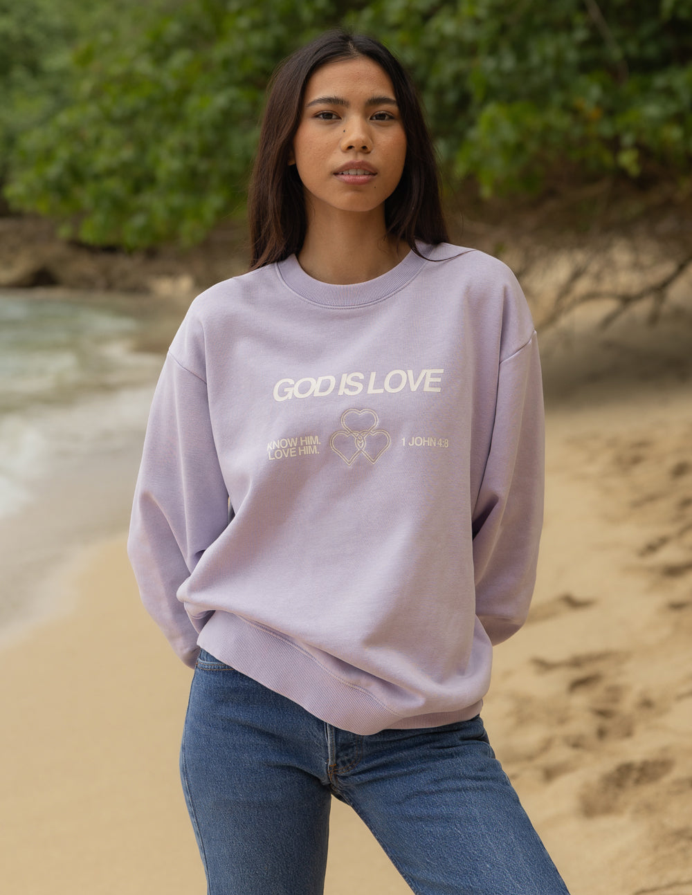 Lavender unisex crewneck sweatshirt with “GOD IS LOVE” front text