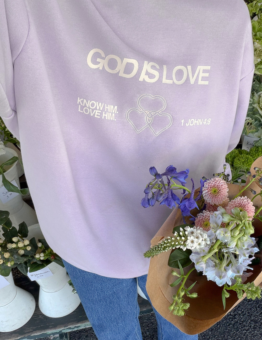 Lavender unisex crewneck sweatshirt with 'GOD IS LOVE' chest graphic
