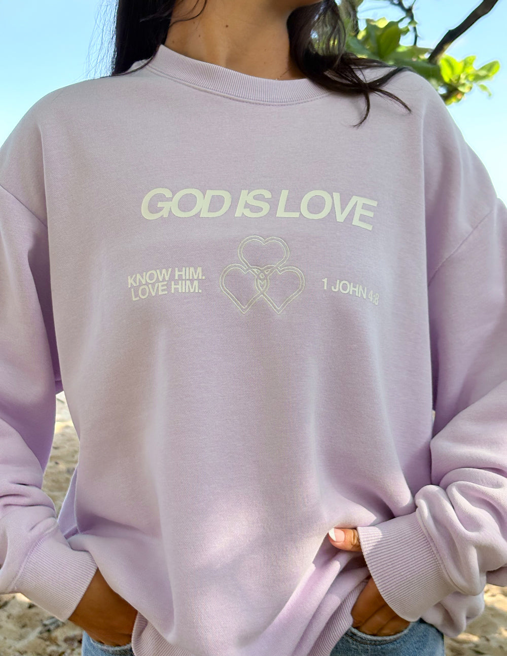 Lavender unisex crewneck sweatshirt with 'God Is Love' and heart logo