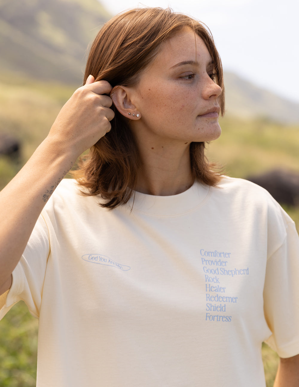 Cream unisex short-sleeve T-shirt with small left chest graphic text